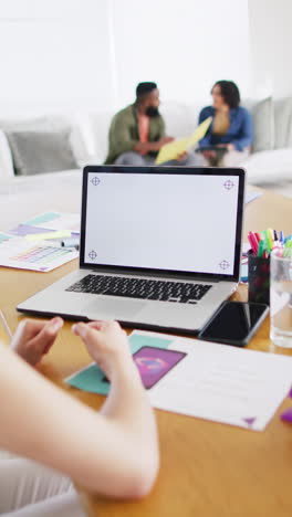 vertical video of diverse woman making laptop video call, copy space on screen, slow motion