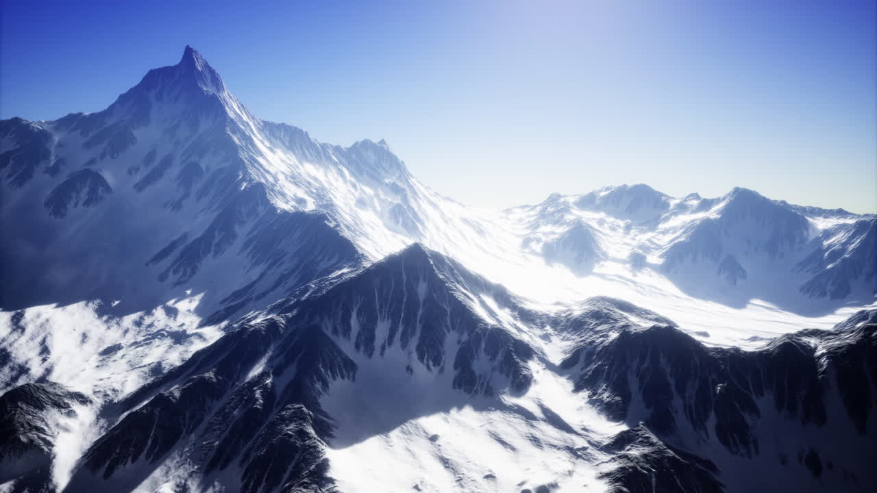 Majestic snow covered mountains reaching towards the horizon at dawn