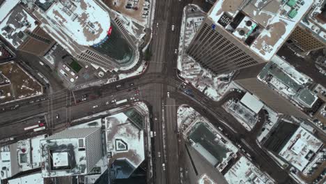 descending overhead vehicle traffic 4k time lapse winter drone shot canadian roadway trans highway one intersection portage avenue and main street capital city downtown winnipeg manitoba canada