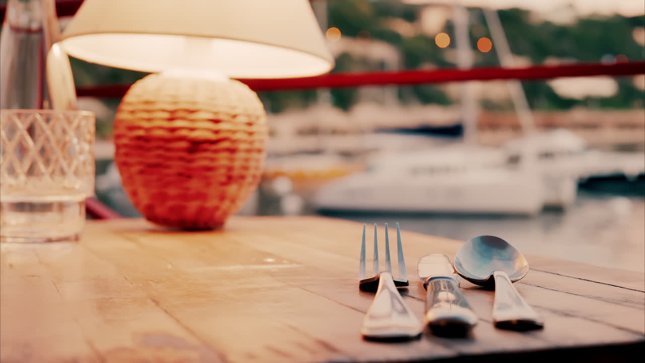 Close up view of a set table and the atmosphere at a restaurant near a port in the south of France