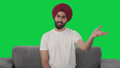 happy sikh indian man talking to the camera green screen