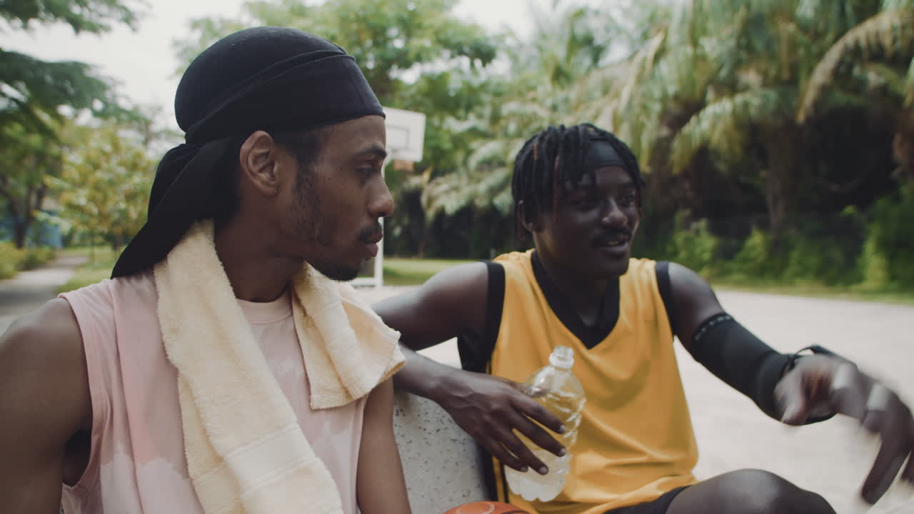 Friends Resting on Bench after Basketball Training