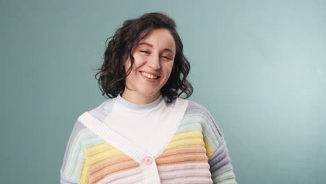 happy woman looking at camera and smiling while standing over an isolated background.