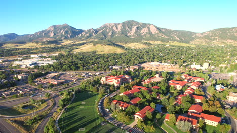 cars driving near the university of colorado campus on a peaceful summer morning during sunrise