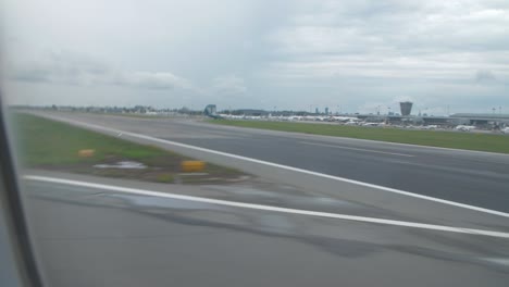 Point-of-view-from-airplane-window-landing-on-airport-runway-after-flight