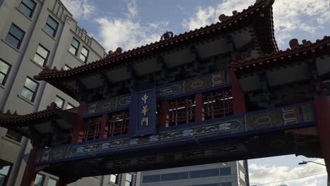 beautiful tilting up shot of the famous seattle chinatown international district entrance gate near the subway and restaurants on a sunny summer day in washington, usa