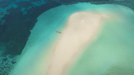 Aerial-View-Of-Boat-At-Sandbar-Of-Mnemba-Island-With-Clear-Blue-Sea-In-Summer