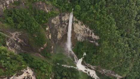 High aerial view of Seerenbach Falls surrounded by cliffs and forest in Switzerland