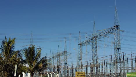 wide shot of a hydroelectric power station with the high voltage distribution lines exiting the sector