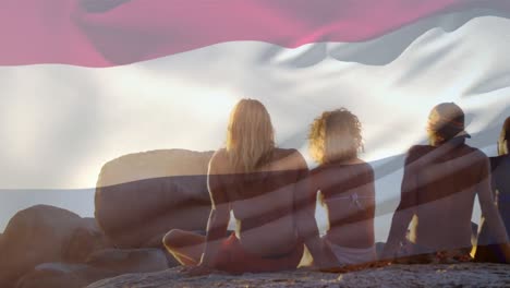 Animation-of-flag-of-netherlands-over-diverse-group-of-friends-at-beach