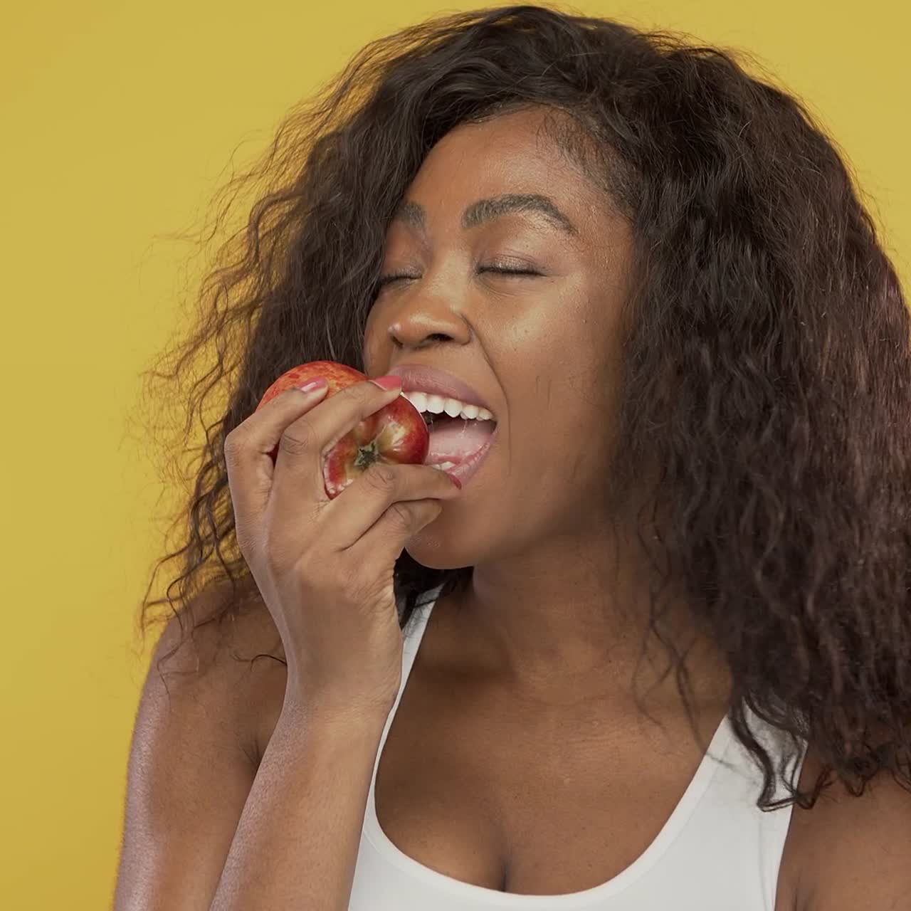 Black woman eating fresh apple