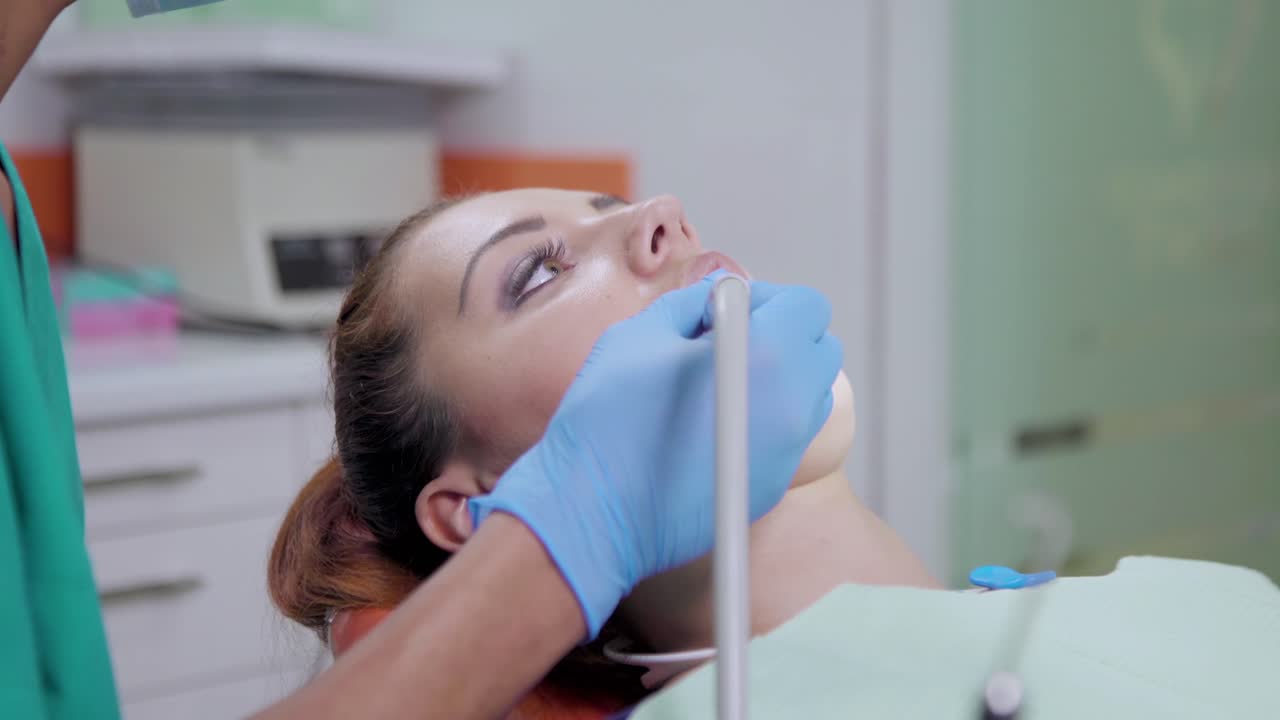 Dentist working with handpiece in patient mouth