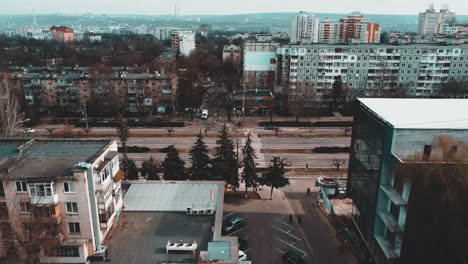 Flying-over-the-buildings-and-the-road-in-Chisináu,-Moldova