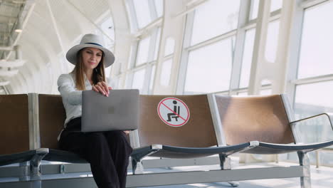 woman working on laptop at airport