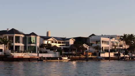 sunset reflecting on waterfront houses and calm water