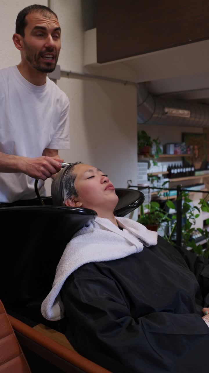 Woman getting her hair washed at a salon