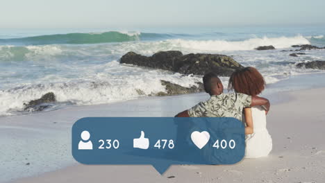 animation of people, thumbs up and heart icons with numbers over couple embracing on beach