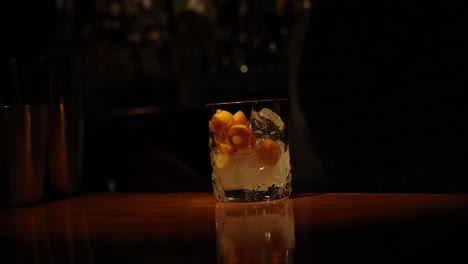 bartender pouring and serving a cocktail