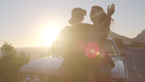 portrait of couple standing next to classic car