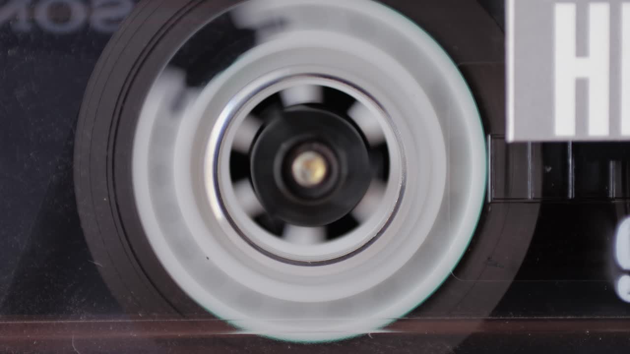 Retro radio tape recorder, audio cassette close-up. Listening to music, old radio boom box player, macro of vintage music listening.