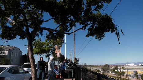 outdoor scene with media crew filming near an an airport observation point