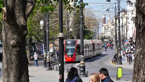 street scene in istanbul with tram and people walking