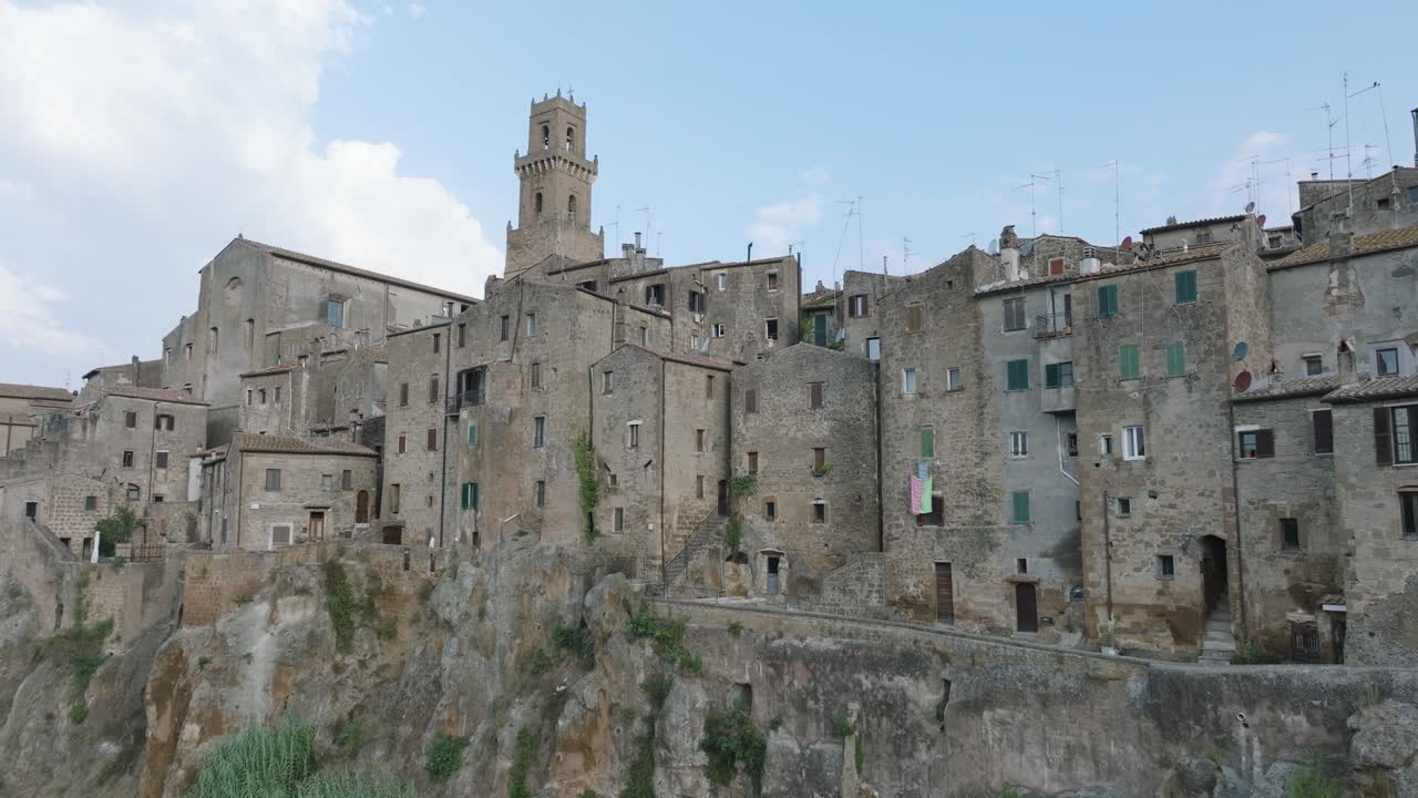 Aerial Drone view of the hilltop Medieval town of Pitigliano, Tuscany in morning light, with close up of old buildings, in 4K