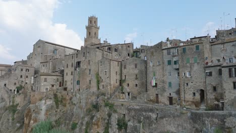 aerial drone view of the hilltop medieval town of pitigliano, tuscany in morning light, with close up of old buildings, in 4k