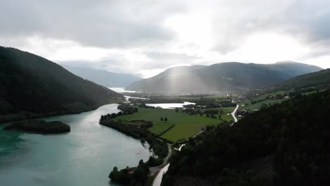 rain falling from the clouds through light rays filmed with a drone from a far