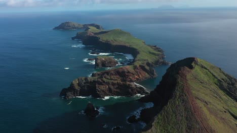 drone shot of the islands in madeira with a small trail leading up to the peak of a cliff