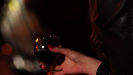 woman holding a glass of red wine