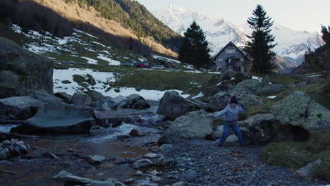 child playing by a mountain stream