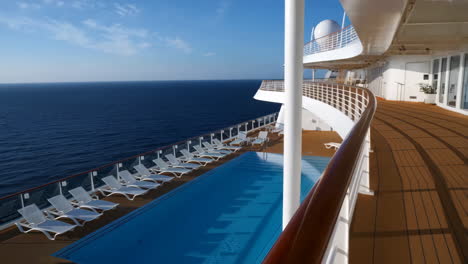 cruise ship deck with swimming pool and ocean view