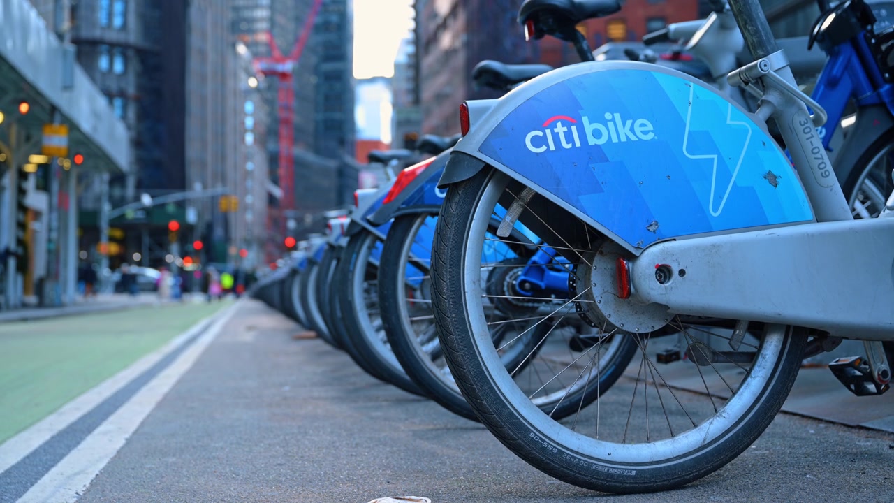 New York, USA, 15 April 2026: Close up of electric Citi Bike rows in Manhattan. Close up view of blue electric rental bikes tires and fenders parked in a row at a docking station in New York.