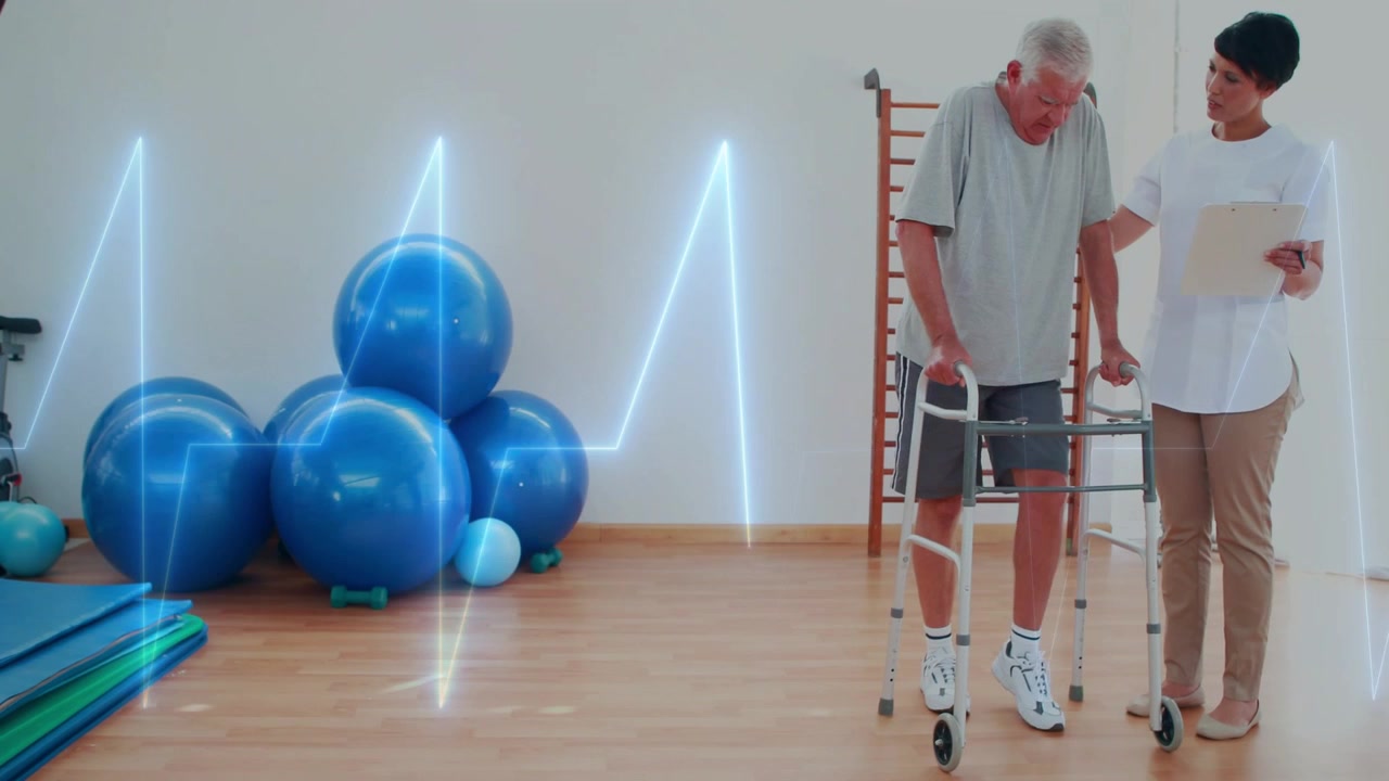 Pasient som går med rullator og tar rehabiliteringssteg, mens terapeut holder en klemme og overvåker EKG-overlegg.