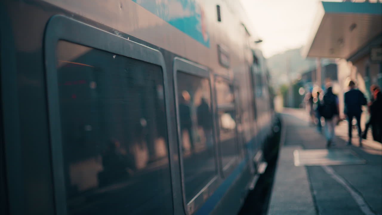 Blurry view of people and trains moving at the Nice Train Station
