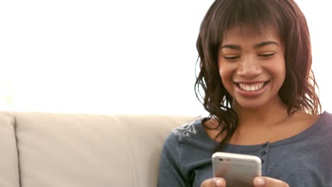 Woman-using-her-phone-on-couch