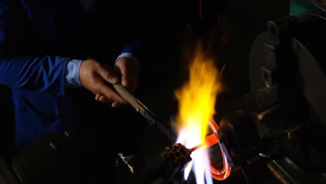 attentive male worker making glass in glass factory 4k