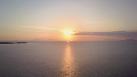 aerial view of beautiful ocean sunset in thailand - camera backwards tracking