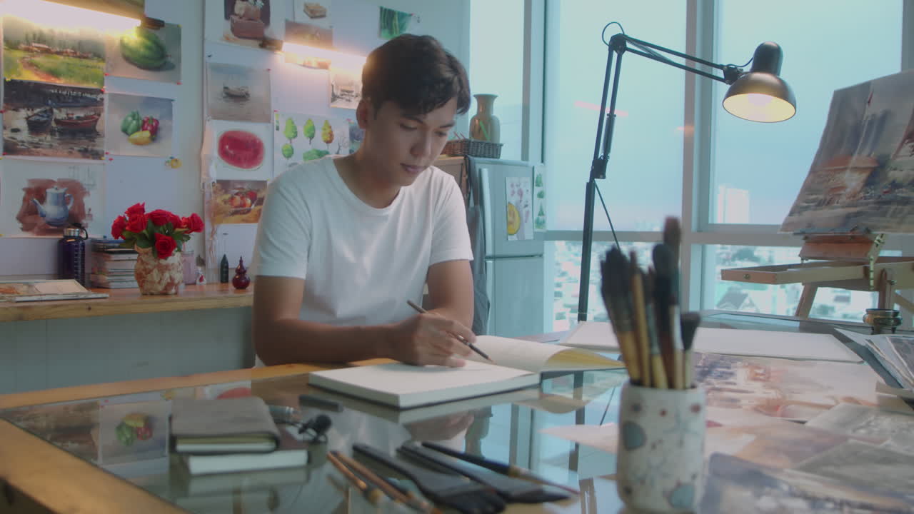 Asian Man Walking in Art Studio and Drawing Sketch