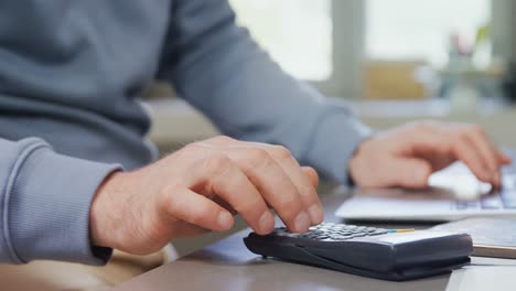 Man calculating on calculator 4k
