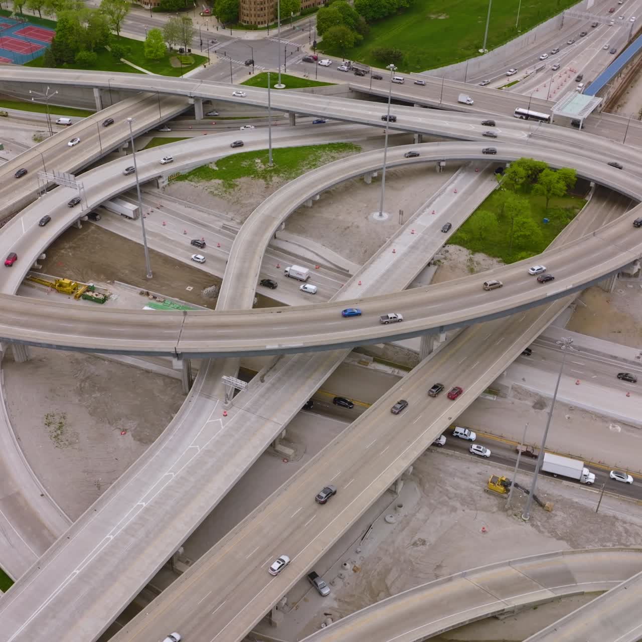 Cars running along the complicated system of roads in Chicago, Illinois. Drone descending over roundabouts of metropolis