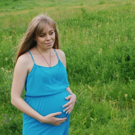 pregnant woman walking through a meadow