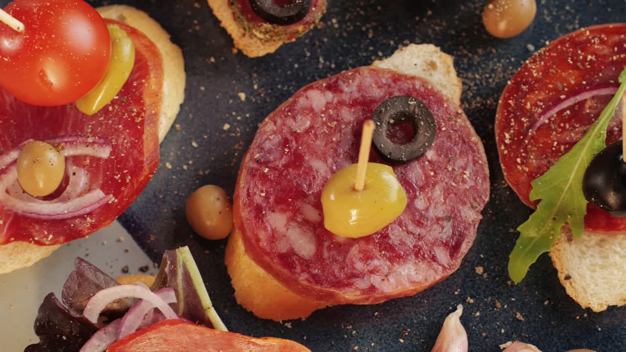 Mix of spanish pork sausages, Cutting board of appetizing catalonian snack - fuet, jamon, chorizo, olives, supermarket tapas food in spain, traditional cuisine.