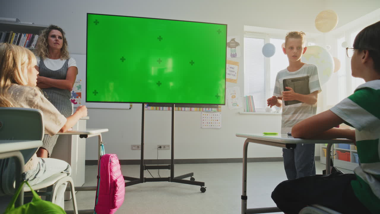 Elementary School Boy Giving Presentation About Solar System and Planets Using Digital Screen
