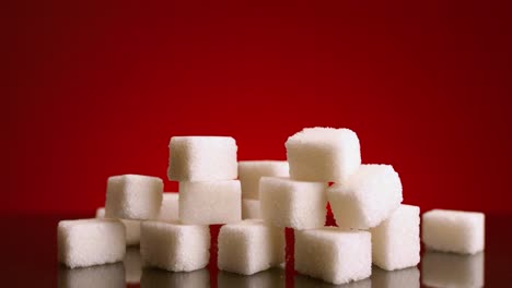 sugar cubes on red background