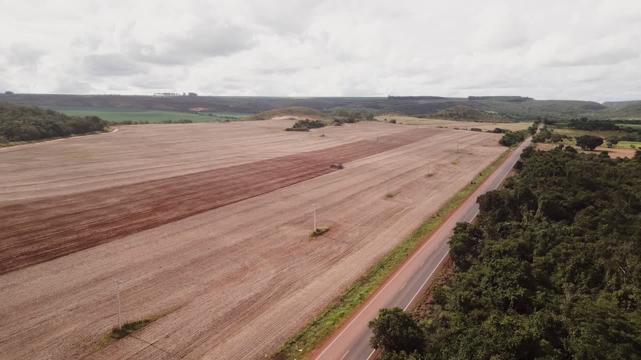 Extensive farmland with active planting and soil preparation in Formosa, Goiás, Central-West Brazil, showing mechanized agribusiness fields and rural road infrastructure across Cerrado landscape, dron