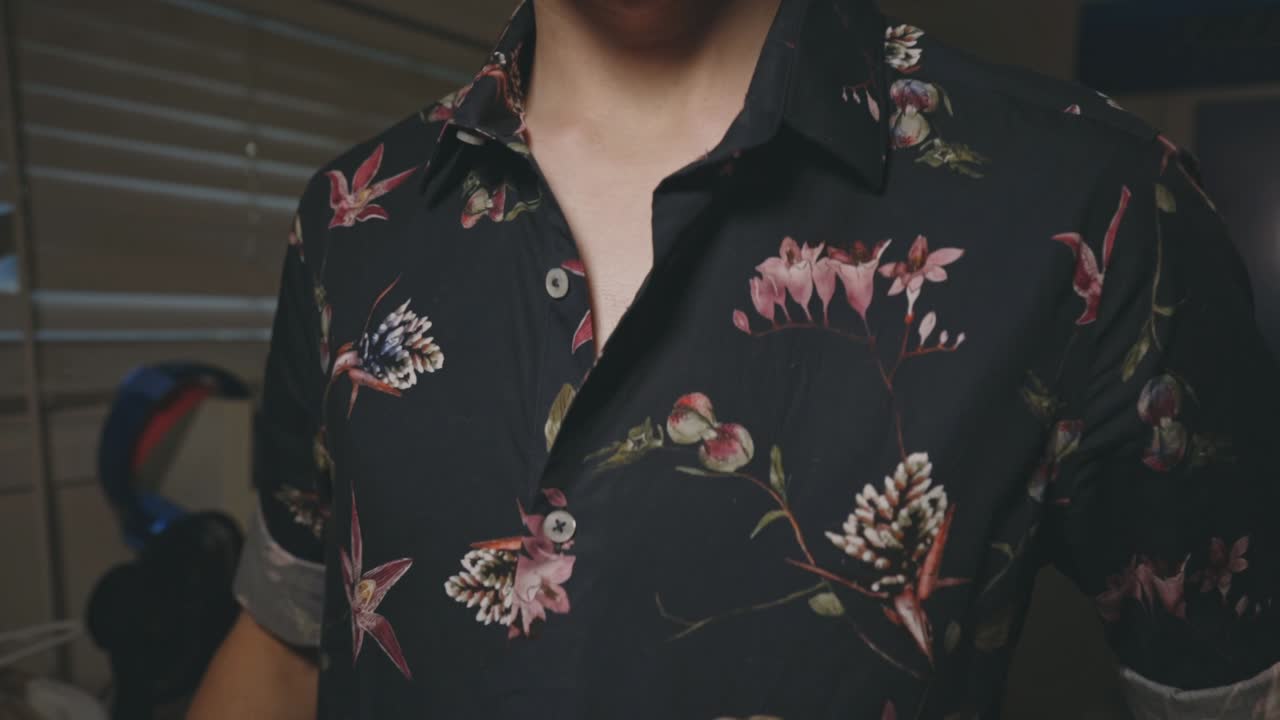 Man Neatly Wearing A Casual Black Floral Button-Up Shirt - Closeup Shot