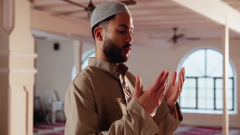 a muslim man is praying in a mosque