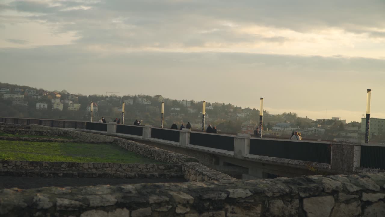 People enjoying the beautiful scenery of the peaceful city of Budapest in Hungary - wide pan